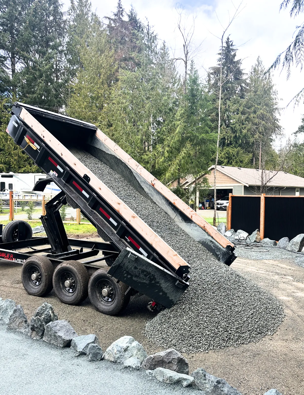 Dump trailer delivering gravel for a Mid Vancouver Island driveway rebuild
