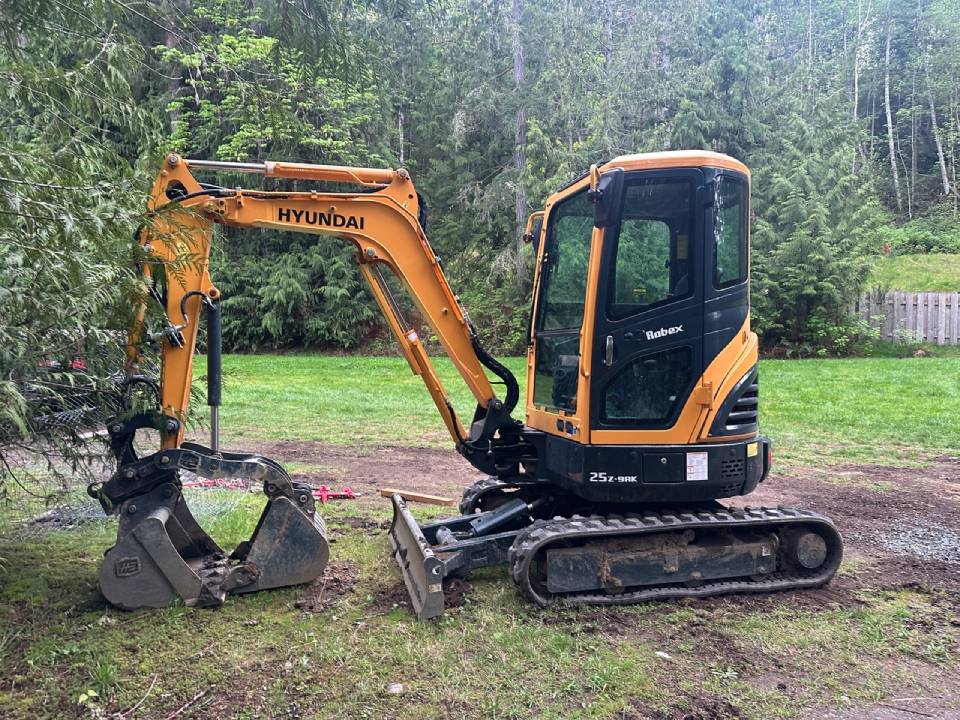 Mini excavator working in a tight Mid Vancouver Island backyard