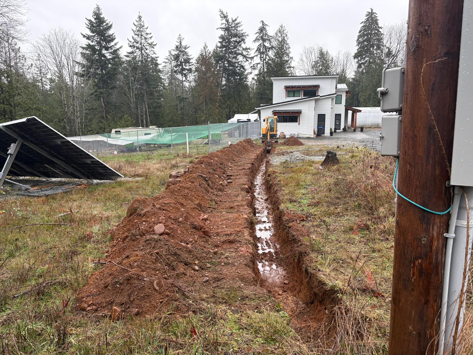 Bobcat E10 running a precision trench on a Mid Vancouver Island property